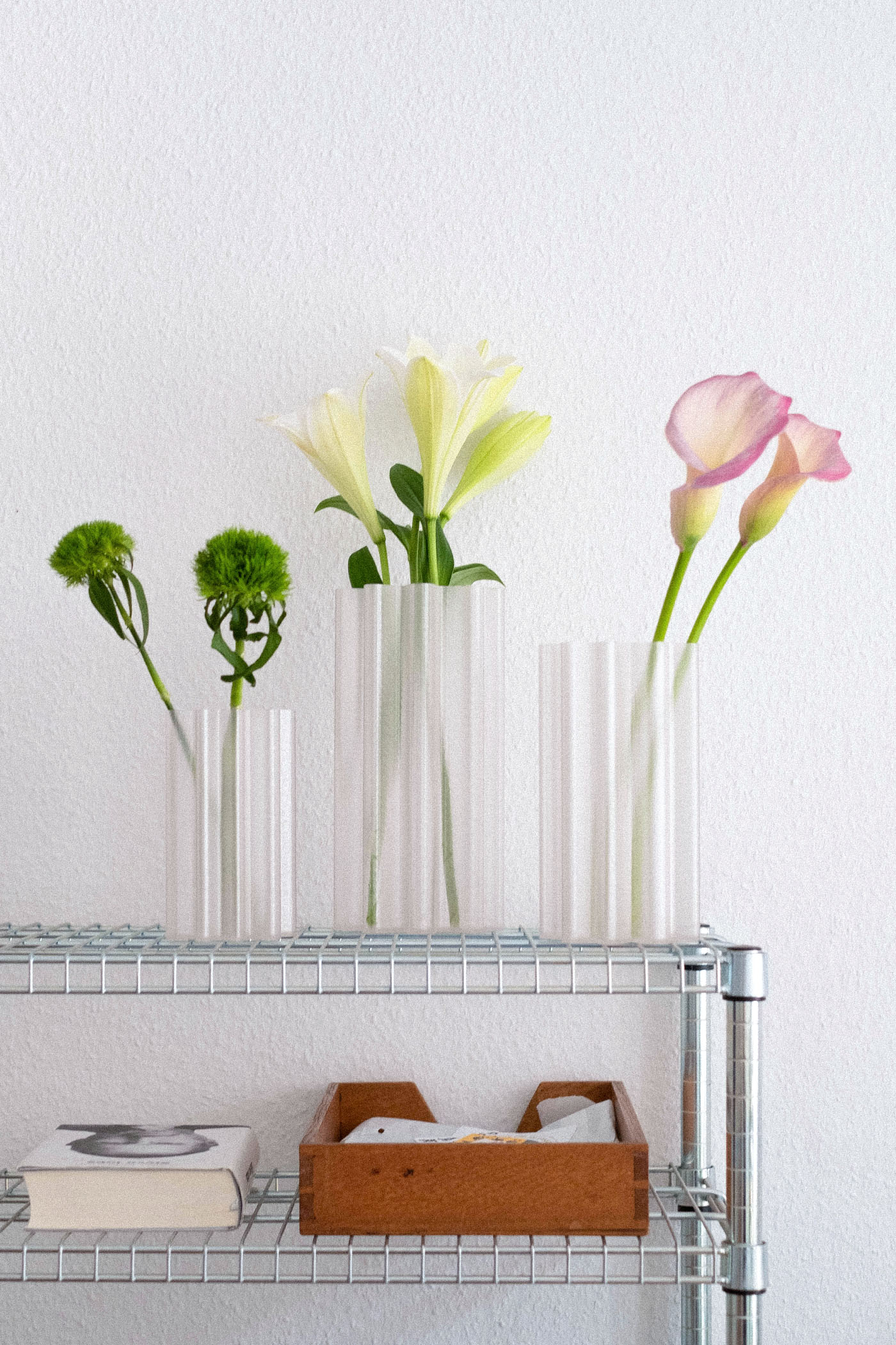 Studio Shorimoma Vala Vase S, M and L on a wire shelf with flowers