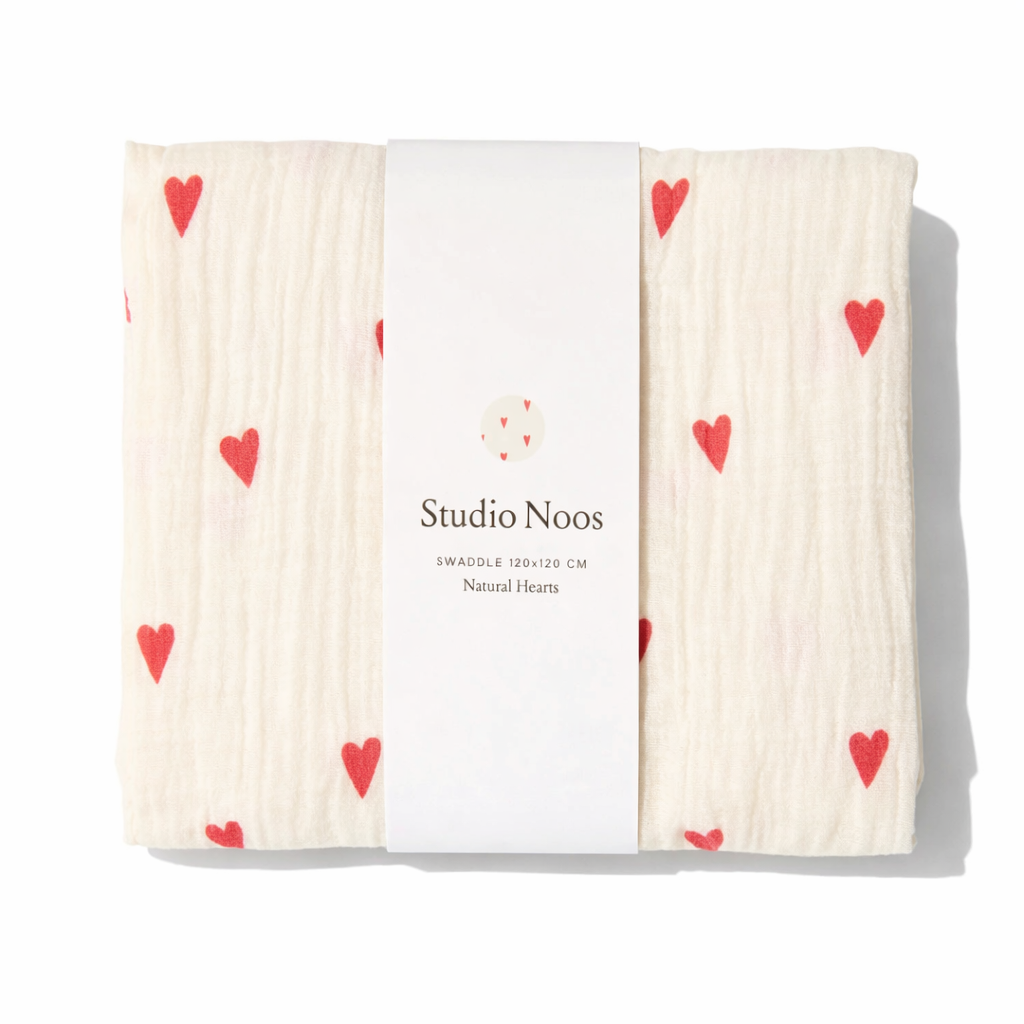 Studio Noos Hearts Swaddle showing soft fabric with heart patterns, perfect for wrapping newborns in cozy comfort.