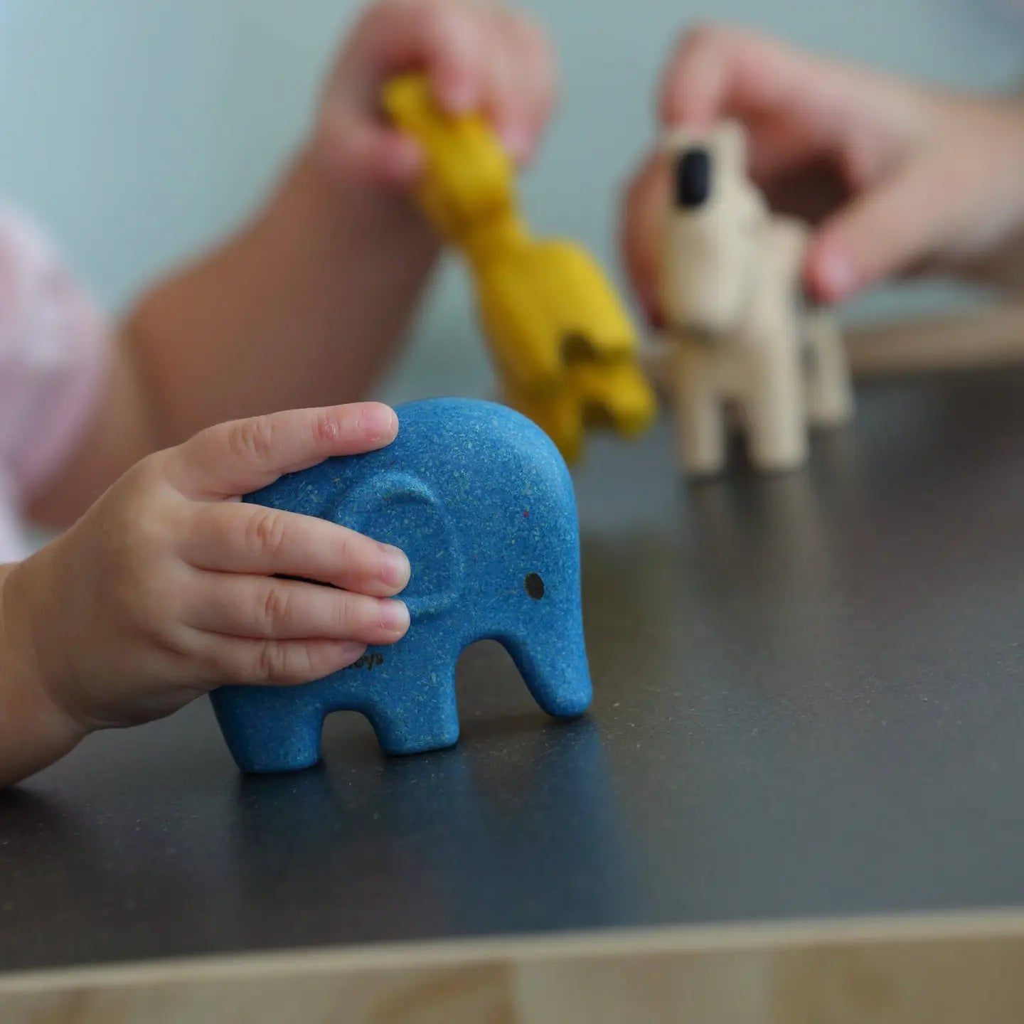PlanToys Wild Animals Set featuring colorful wooden toy animals including lion, elephant, and zebra on a natural background.