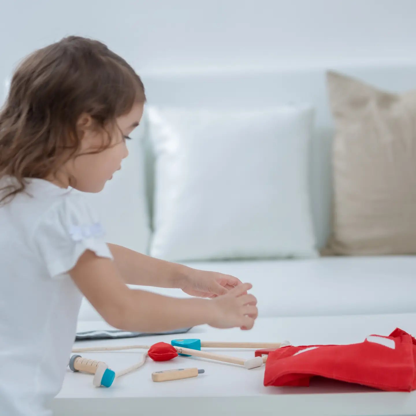 PlanToys doctor play set featuring toy medical tools, stethoscope, and doctor accessories for imaginative role-playing.