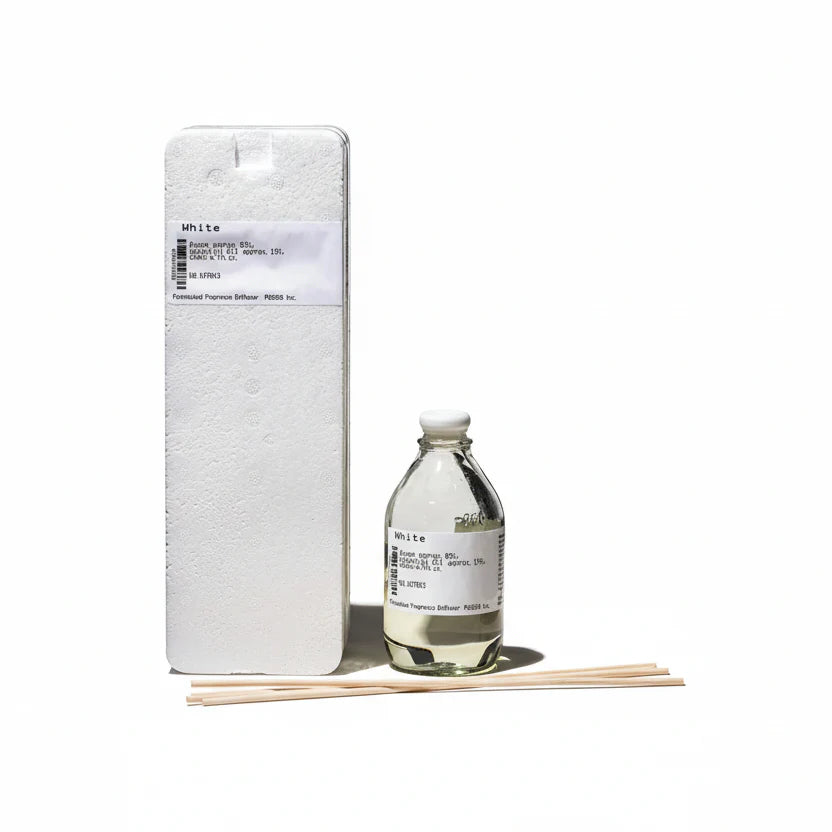 Puebco formulated fragrance diffuser with a sleek design, featuring a glass bottle and reed sticks for aromatic home scent.