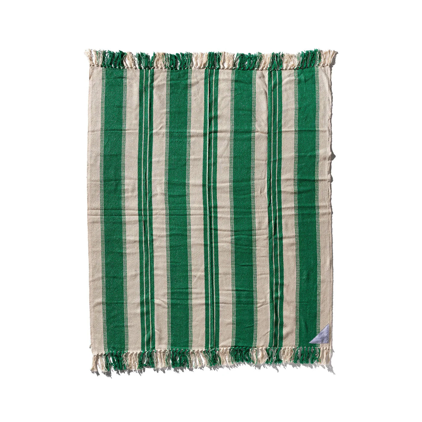 Puebco twill blanket draped over a sofa, showcasing its soft, woven fabric and neutral color for cozy home décor.