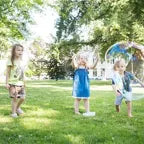 Large XXXXL bubbles created with BS Toys bubble solution, showcasing huge, shimmering soap bubbles floating in the air.