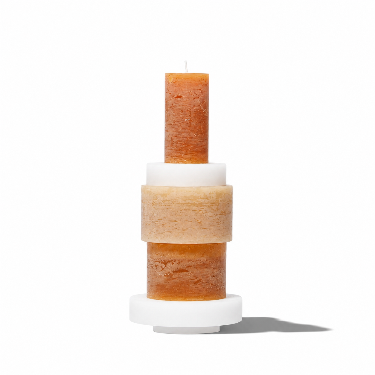 Stack of three modern Candl Stack 03 candles by Stan Editions in neutral tones on a minimalist surface.