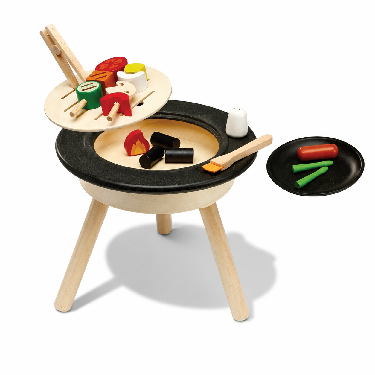 PlanToys table BBQ set with toy grill, utensils, and food items for kids' pretend cooking play.