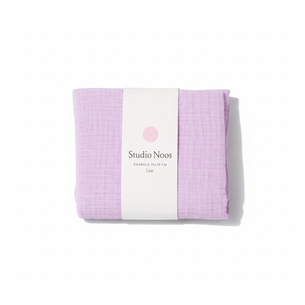 Colorful Studio Noos swaddle blanket displayed folded with soft fabric and vibrant patterns suitable for newborns.