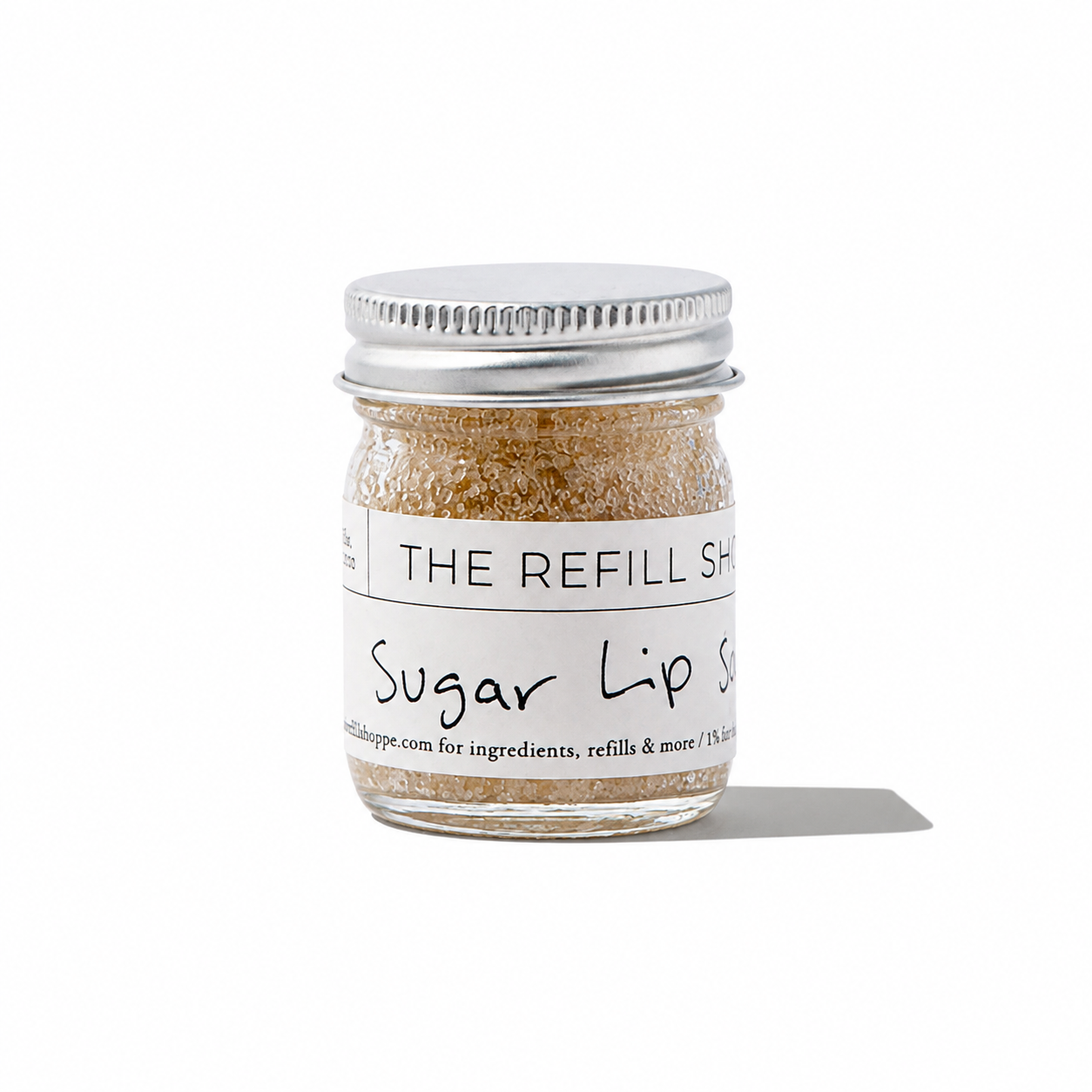 The Refill Shoppe sugar lip scrub in a clear jar, showing textured sugar exfoliant for soft, smooth lips.