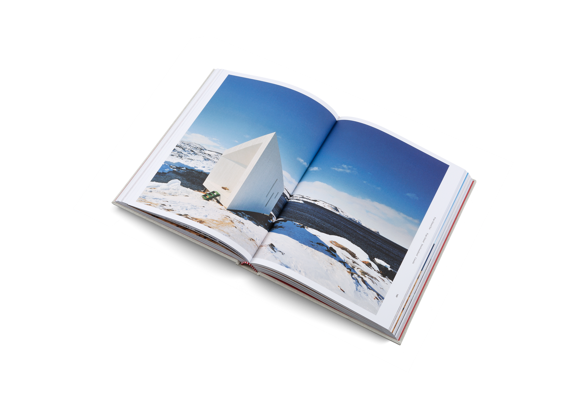 Open book titled "Remote Places To Stay" by Gestalten & teNeues, featuring scenic travel destinations on its pages.