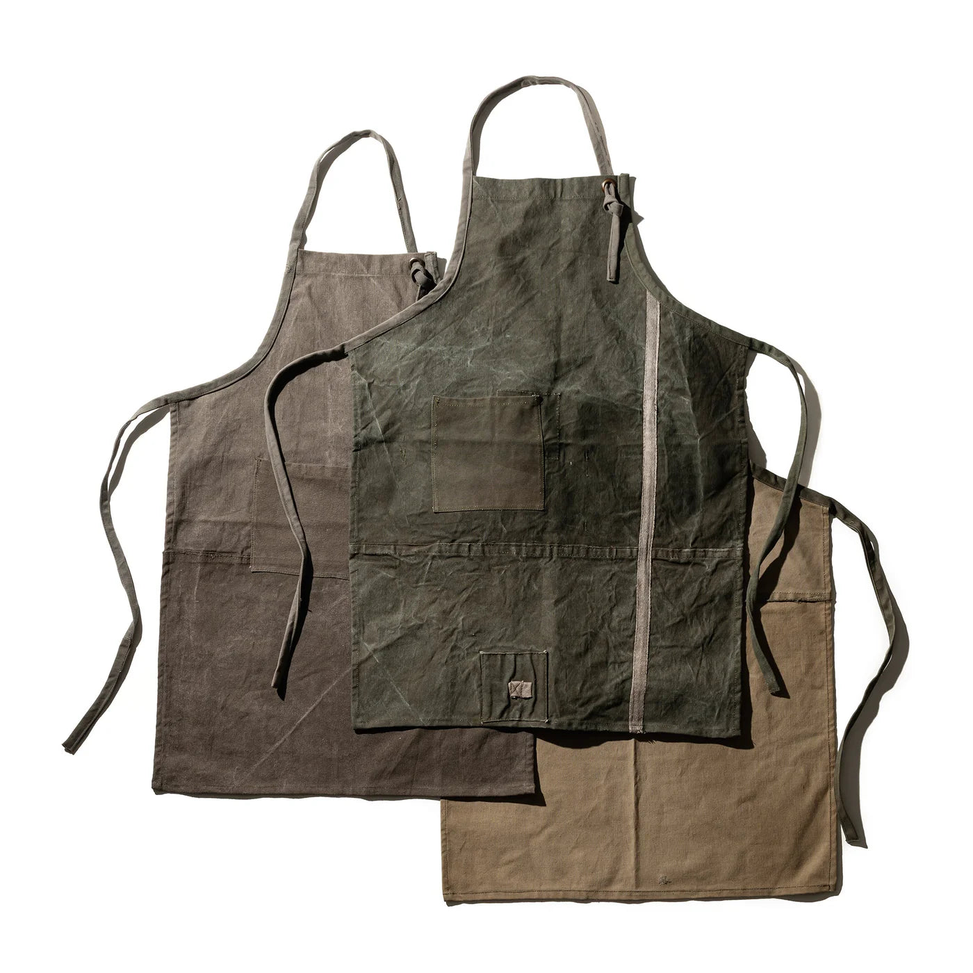 Vintage Tent Fabric Apron by Puebco featuring durable, rustic tent material with adjustable straps and front pocket.