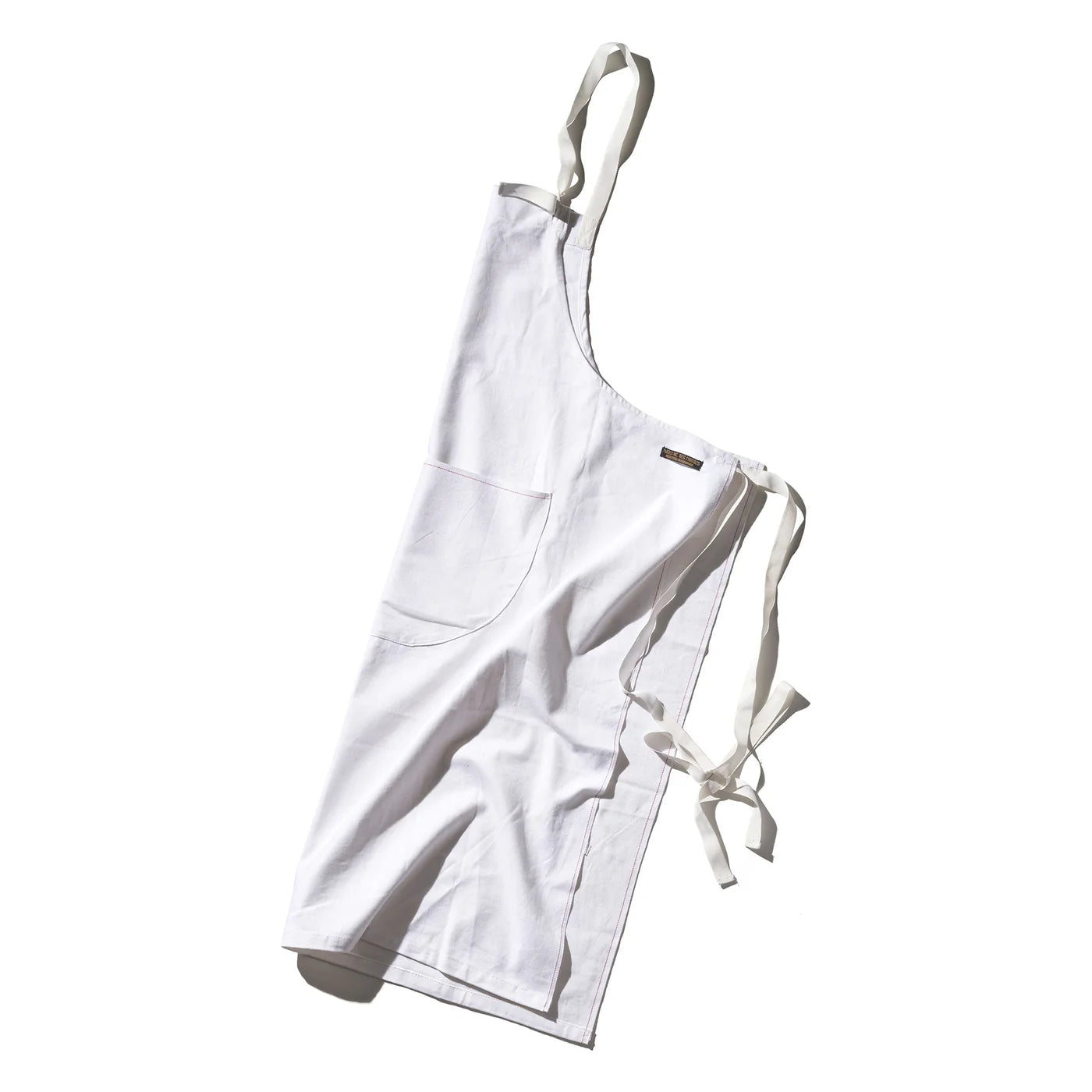 Puebco utility apron with multiple pockets, made of durable fabric, ideal for cooking, gardening, or workshop tasks.