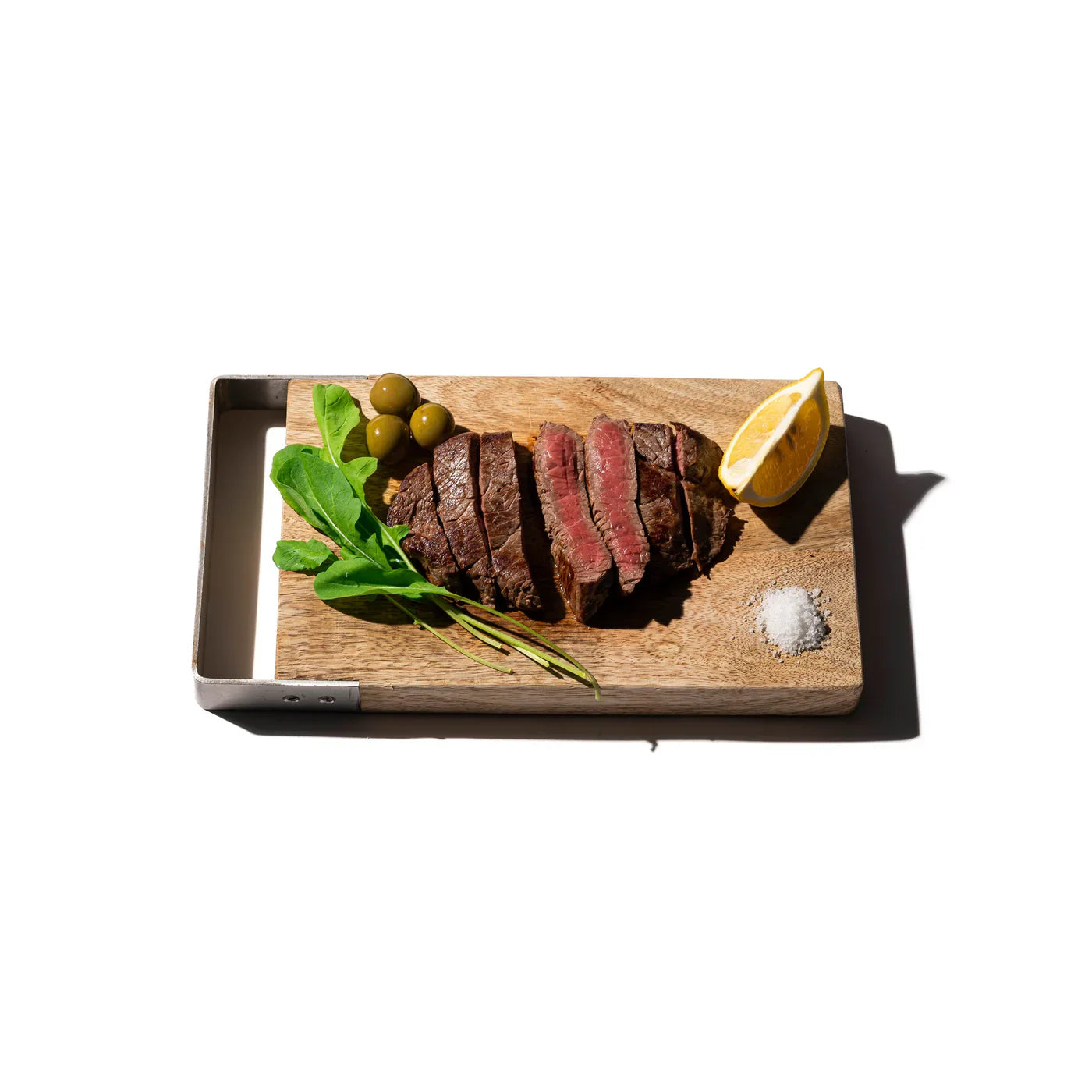 Puebco cutting board made of durable wood with a smooth surface and natural grain, ideal for kitchen food preparation.