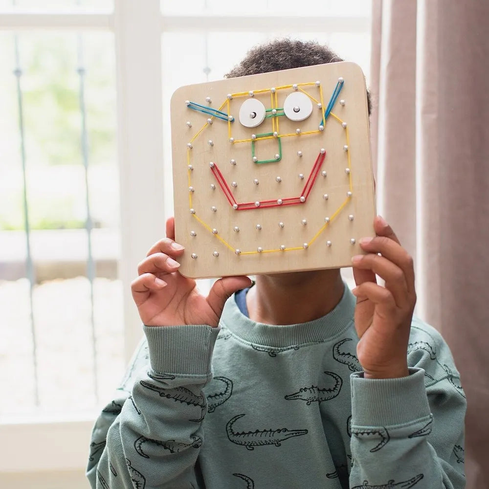 Colorful BS Toys geoboard with rubber bands and wooden pegs for creative geometric play and educational activities.