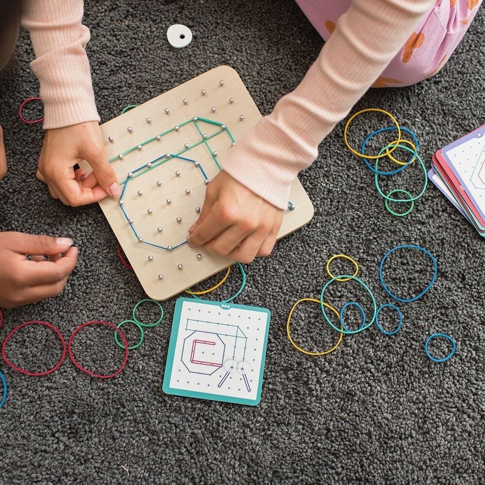 BS Toys geoboard with colorful rubber bands and numbered pegs for creative geometric building and educational play.