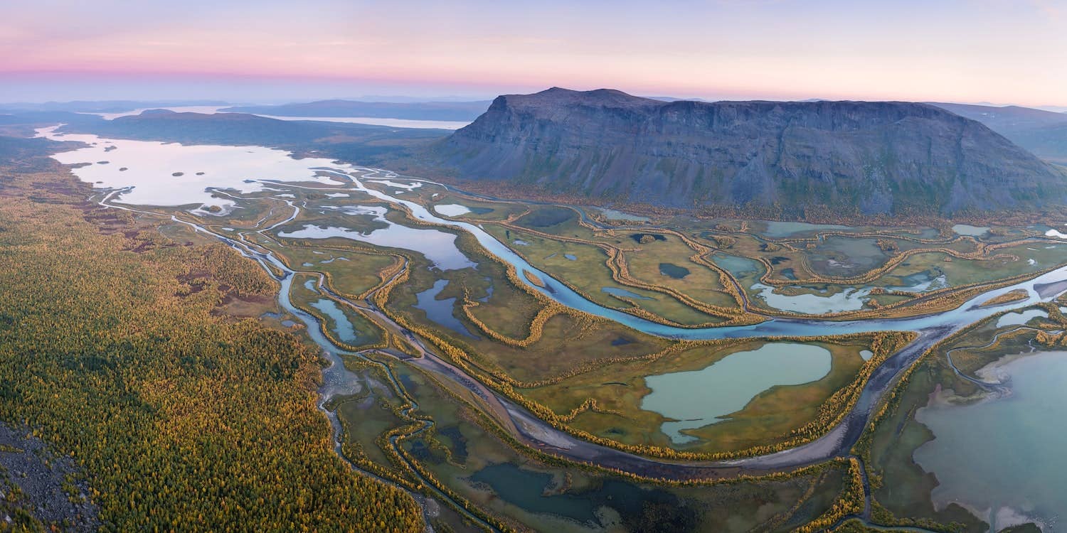 Open travel book "Wanderlust Nordics" by gestalten & teNeues showing scenic Nordic landscapes and cultural images inside.