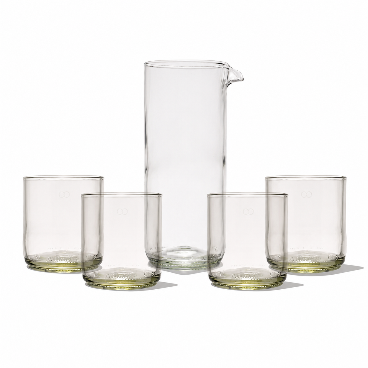 Rebottled carafe with four short tumblers set, clear glass drinkware for serving beverages in a stylish, modern design.