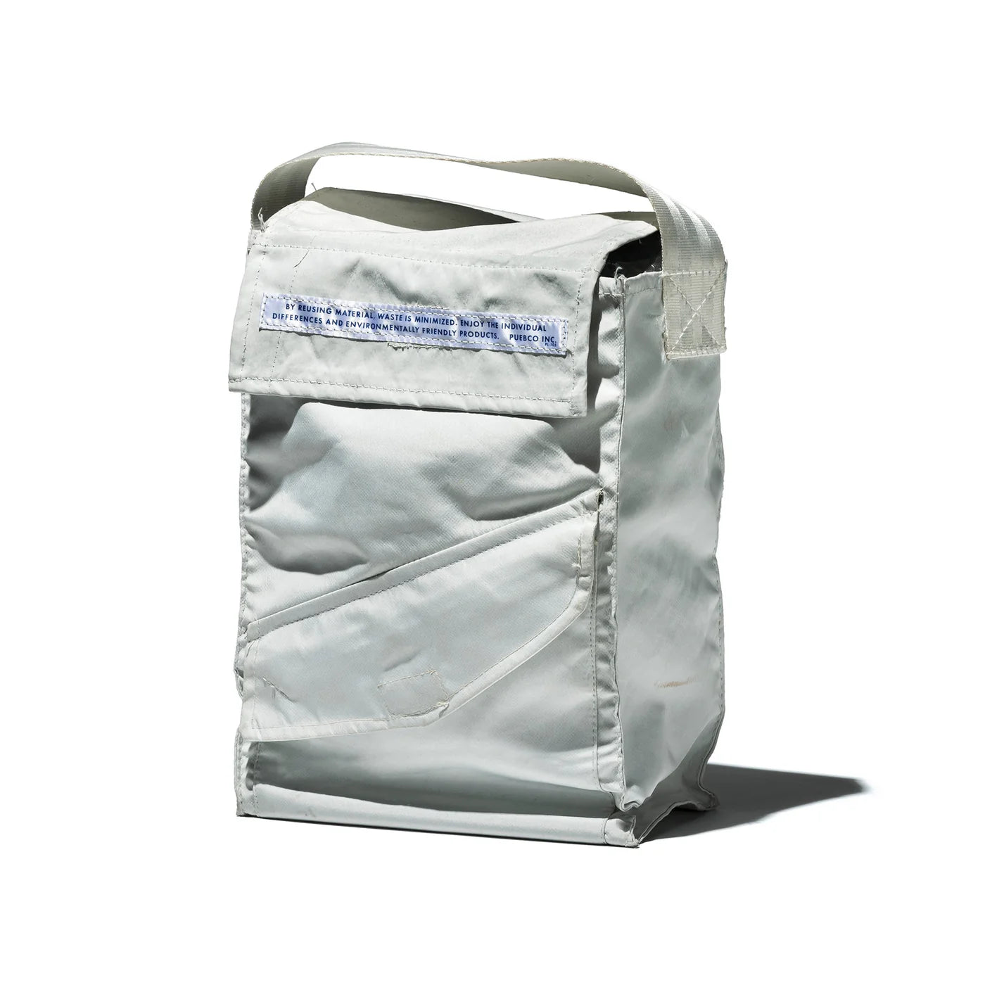 Puebco shoes bag in neutral color with zipper closure, designed for storing and protecting footwear during travel or storage.