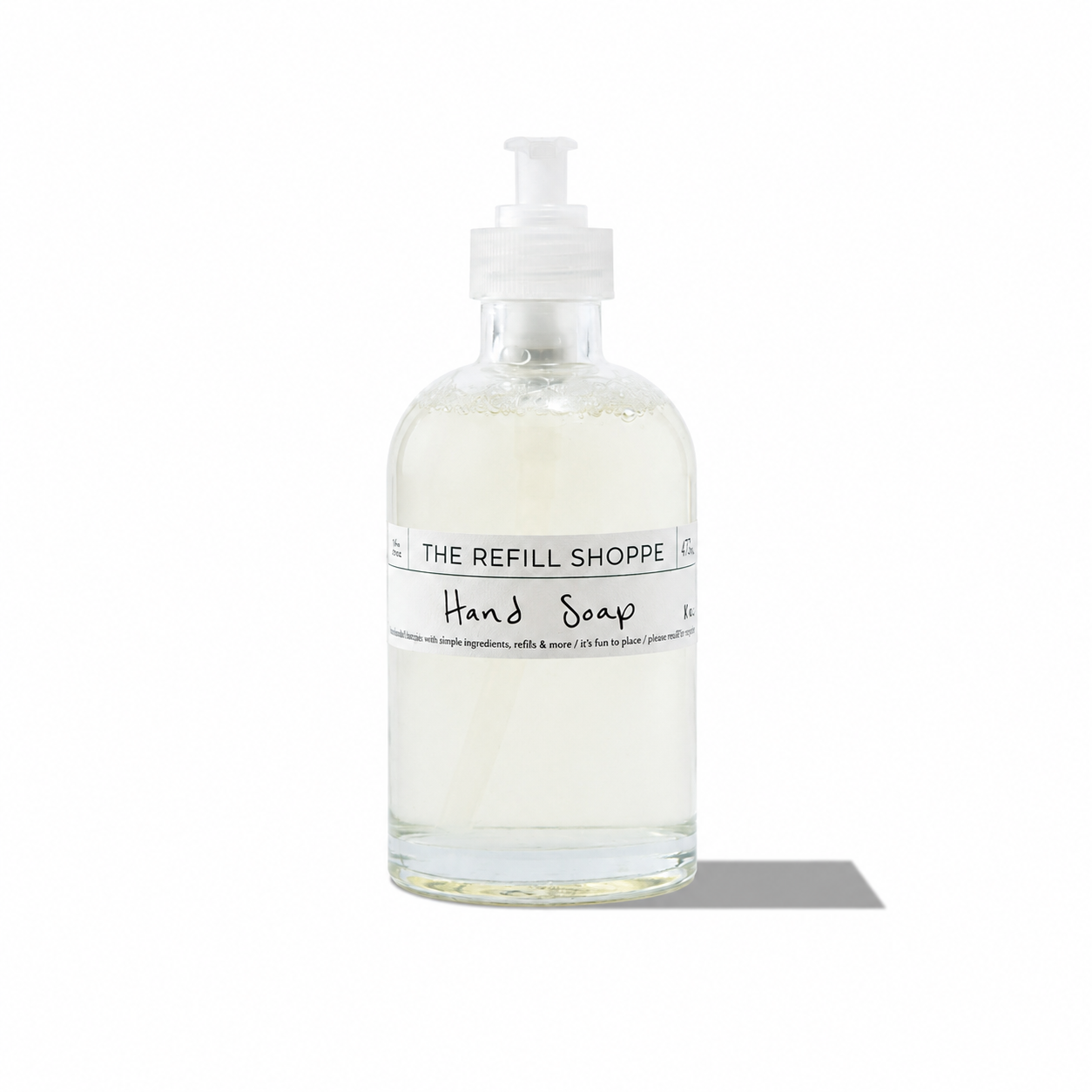 Coconut hand soap from The Refill Shoppe in a clear pump bottle, showcasing a tropical coconut scent for bath and body use.