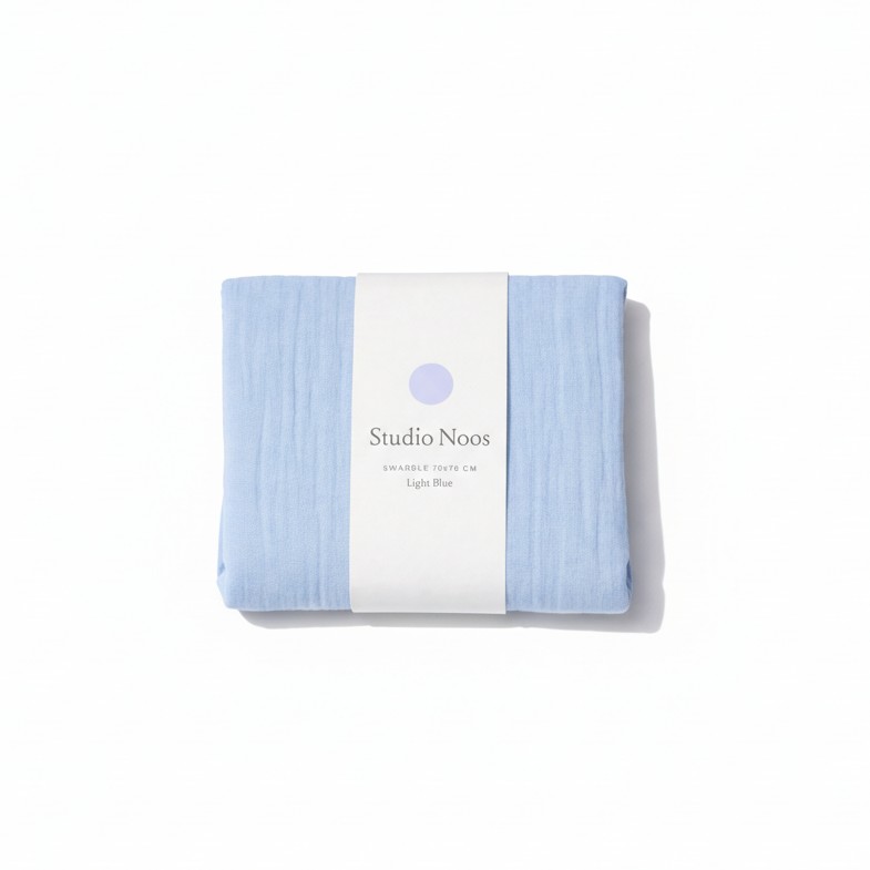 Studio Noos colored swaddle blanket with vibrant pastel hues, soft fabric, and a cozy, lightweight design for babies.