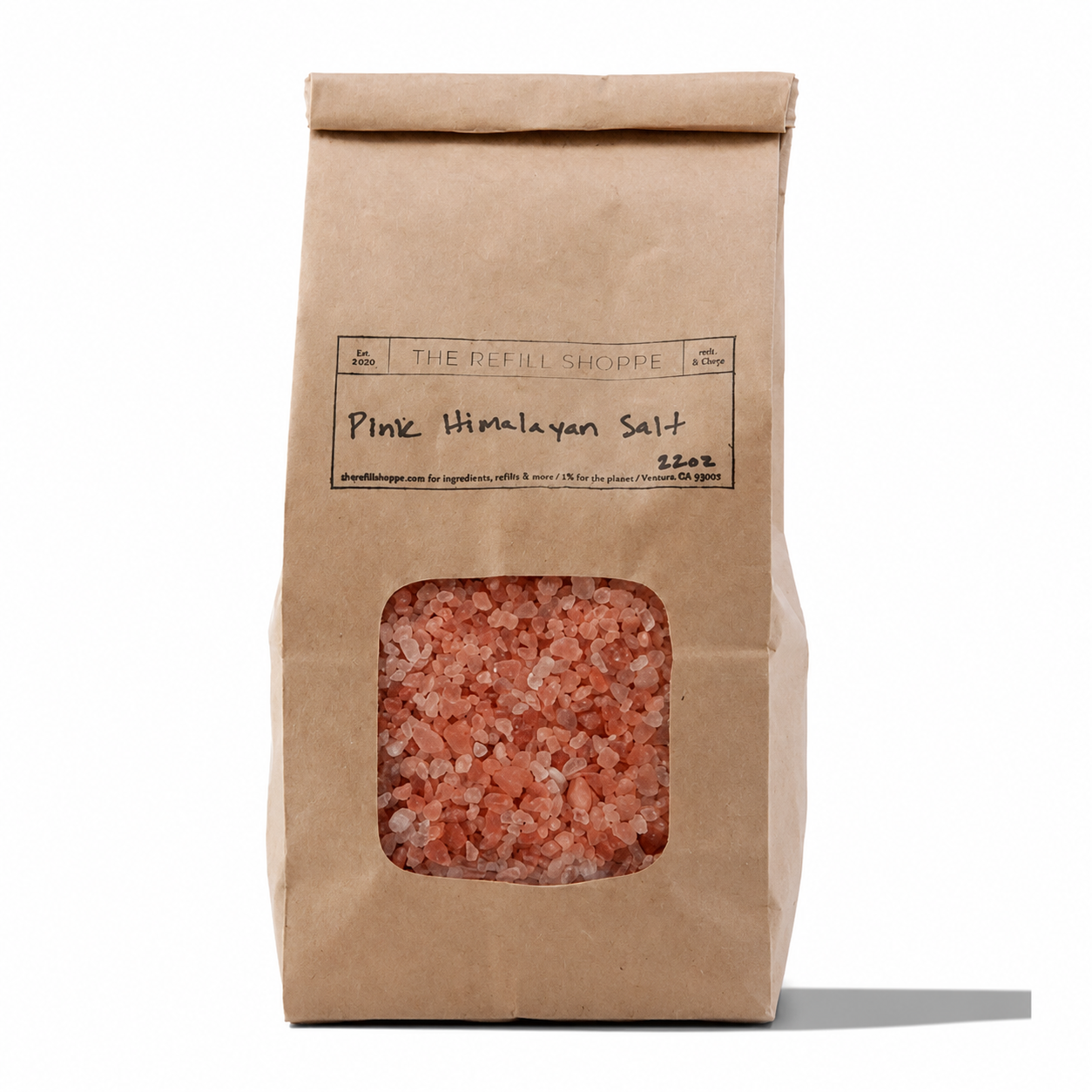 Pink Himalayan bath salts from The Refill Shoppe in a clear glass jar, showing pink crystalline salt with a scoop.
