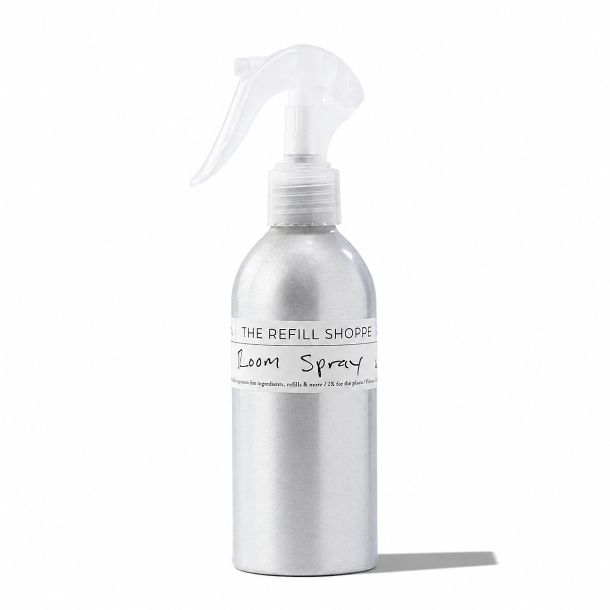 The Refill Shoppe room spray bottle with floral-patterned packaging, designed for freshening indoor spaces.