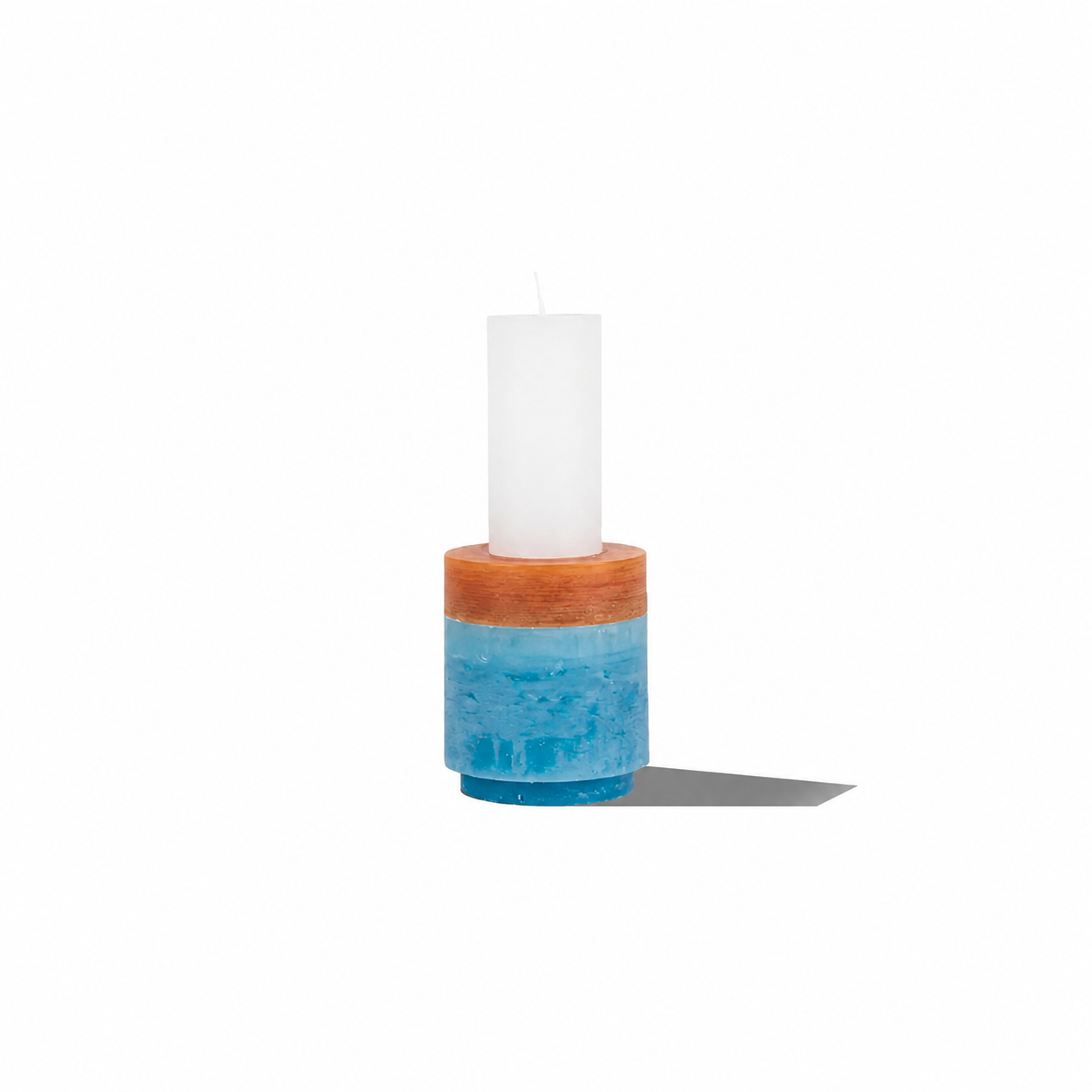 Stack of six modern Candl Stack 02 candles by Stan Editions in various colors, arranged in a decorative display.