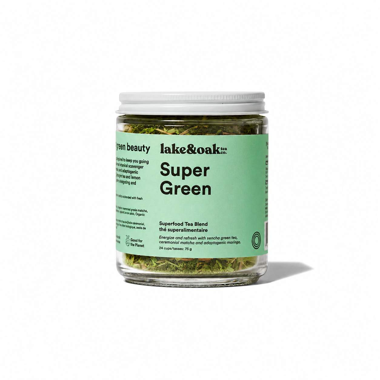 Dry Super Green tea leaves from Lake & Oak Tea Co. in a clear glass jar, showcasing vibrant green tea leaves.