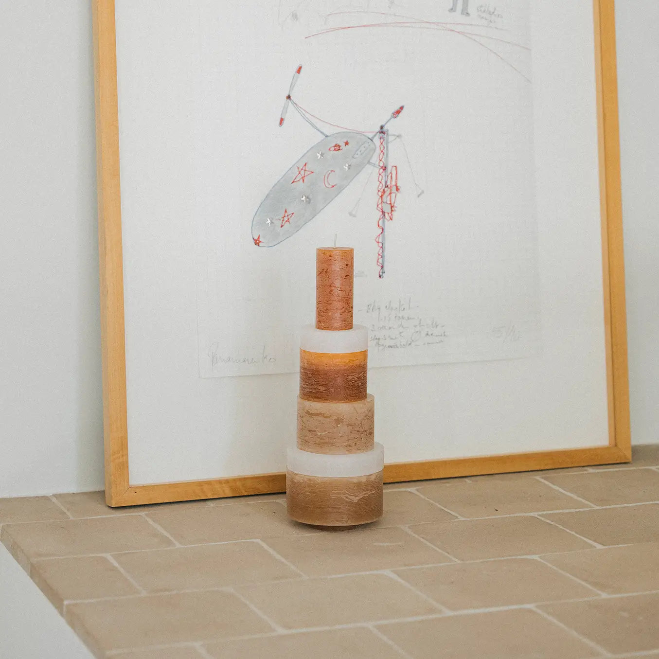 Stack of white candles from Stan Editions Candl Stack 06, arranged in a modern, minimalist display with a soft glow.