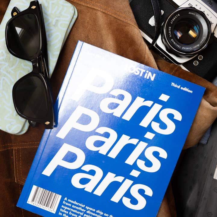 Lost iN City Guides book cover featuring urban exploration and travel tips with vibrant cityscape illustrations.