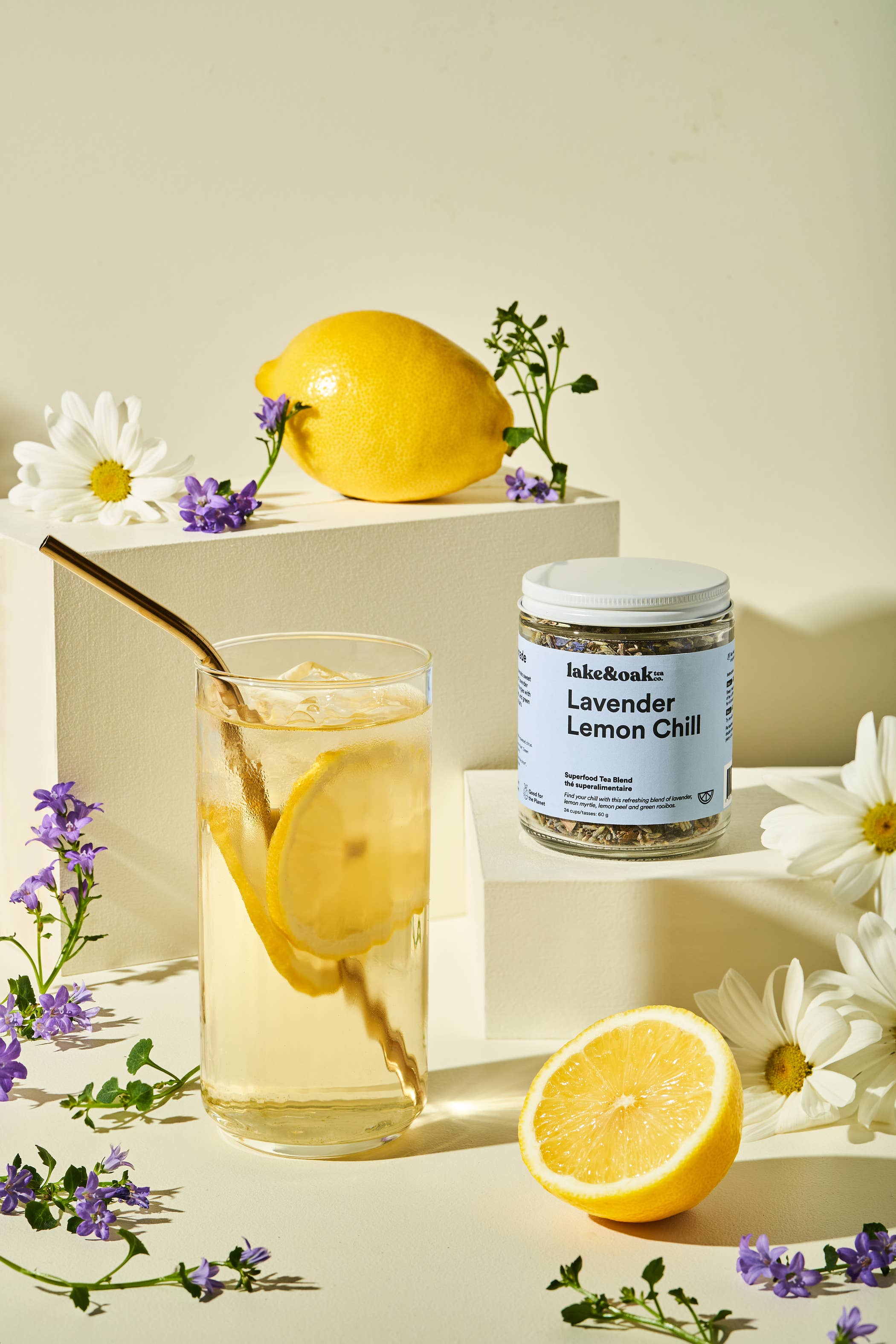 Lavender Lemon Chill tea by Lake & Oak Tea Co. in a clear glass cup with lavender and lemon slices, showcasing a refreshing tea beverage.