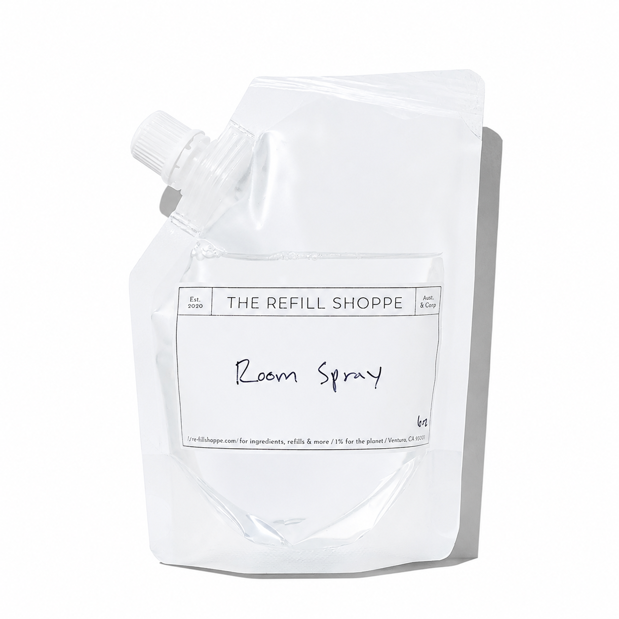 The Refill Shoppe room spray in a clear glass bottle with a spray nozzle, showcasing a fresh and aromatic scent.