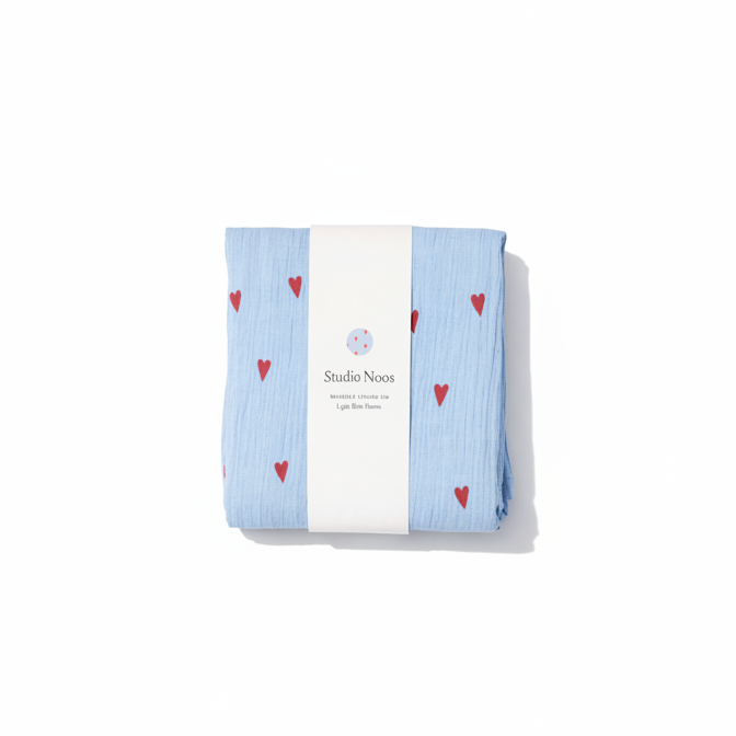 Studio Noos Hearts Swaddle featuring a soft fabric with a heart pattern, perfect for wrapping and soothing babies.