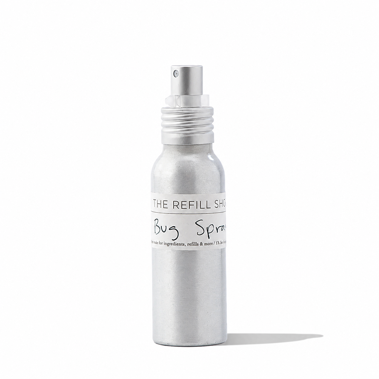 Natural insect repellent bug spray from The Refill Shoppe in a clear spray bottle with a label and green cap.
