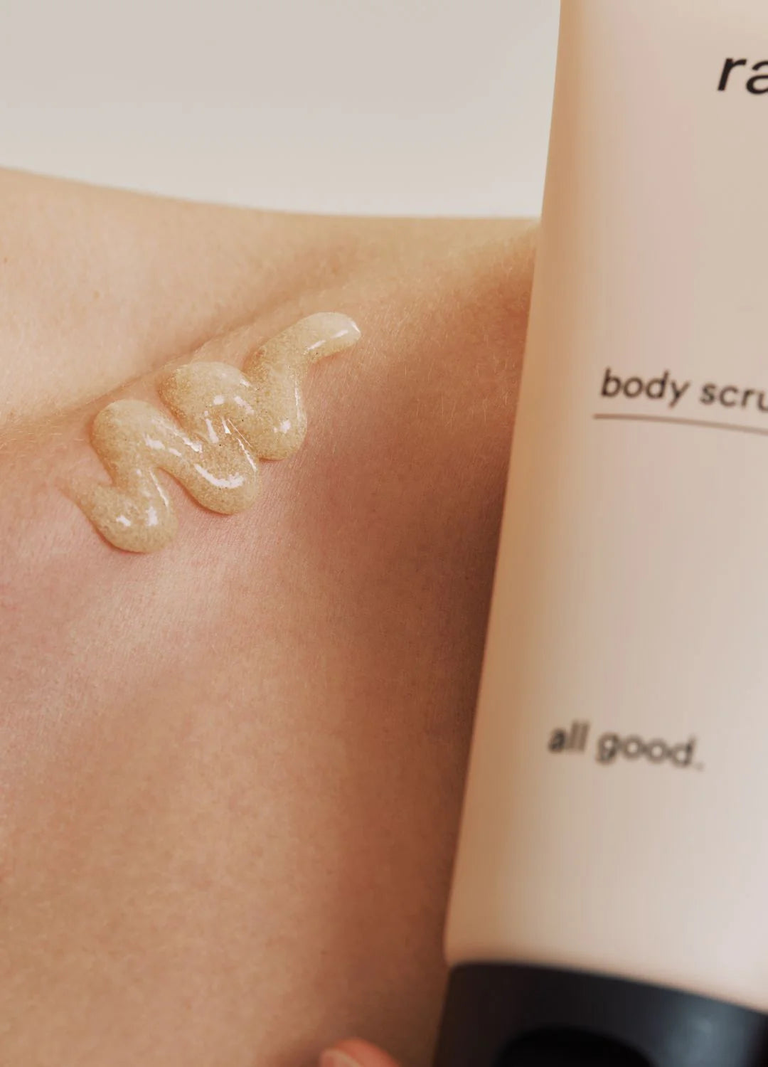 Ray Body Scrub in a jar with exfoliating texture, shown on a neutral background, highlighting smooth skin and natural ingredients.