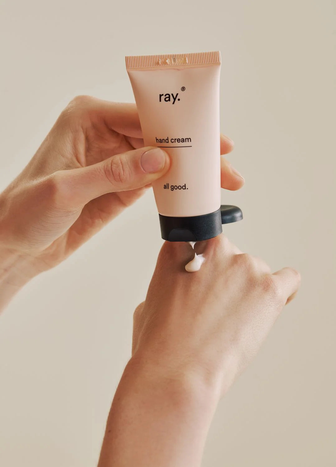 Ray hand cream tube with a smooth, creamy texture, showcasing its moisturizing and nourishing qualities in a natural setting.