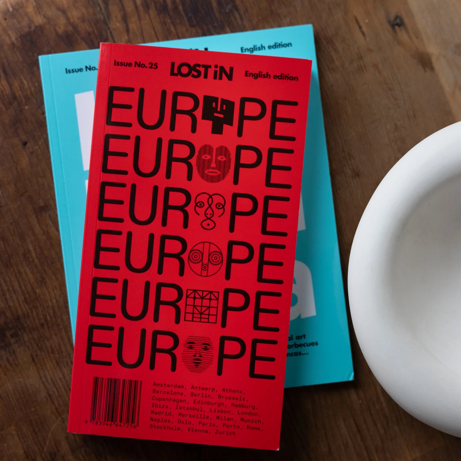 Open book titled "Lost in Europe" from Lost iN books series, featuring a map and travel-themed illustrations.