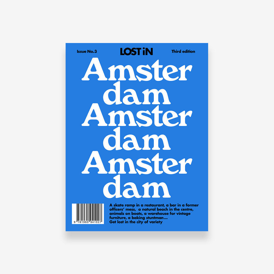 Lost iN Amsterdam city guide book, featuring colorful cover design and images of the city skyline and landmarks.