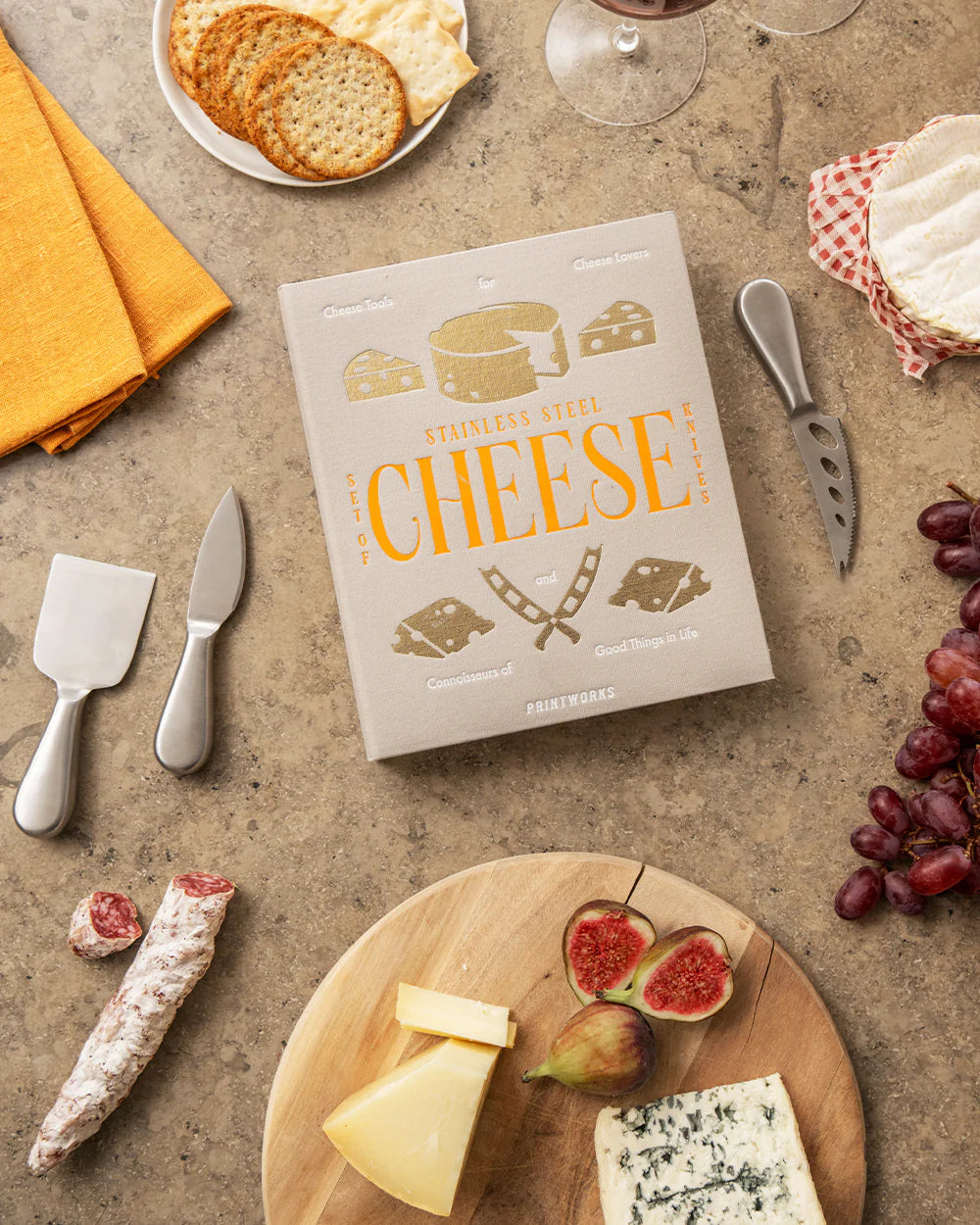 Printworks cheese tools gift set with cheese knives and accessories for cheese lovers, displayed on a wooden board.