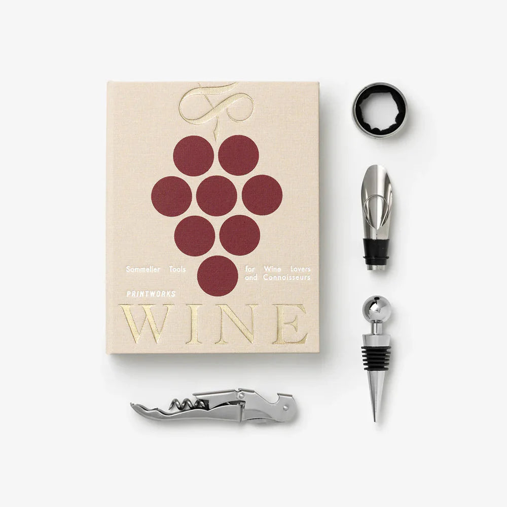 Printworks beige wine tools gift set including corkscrew, wine stopper, and foil cutter arranged on a wooden surface.