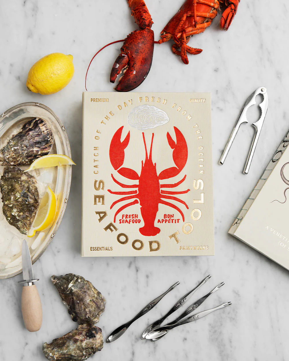 Printworks seafood tools gift set with crab crackers, seafood forks, and picks displayed on a wooden surface.