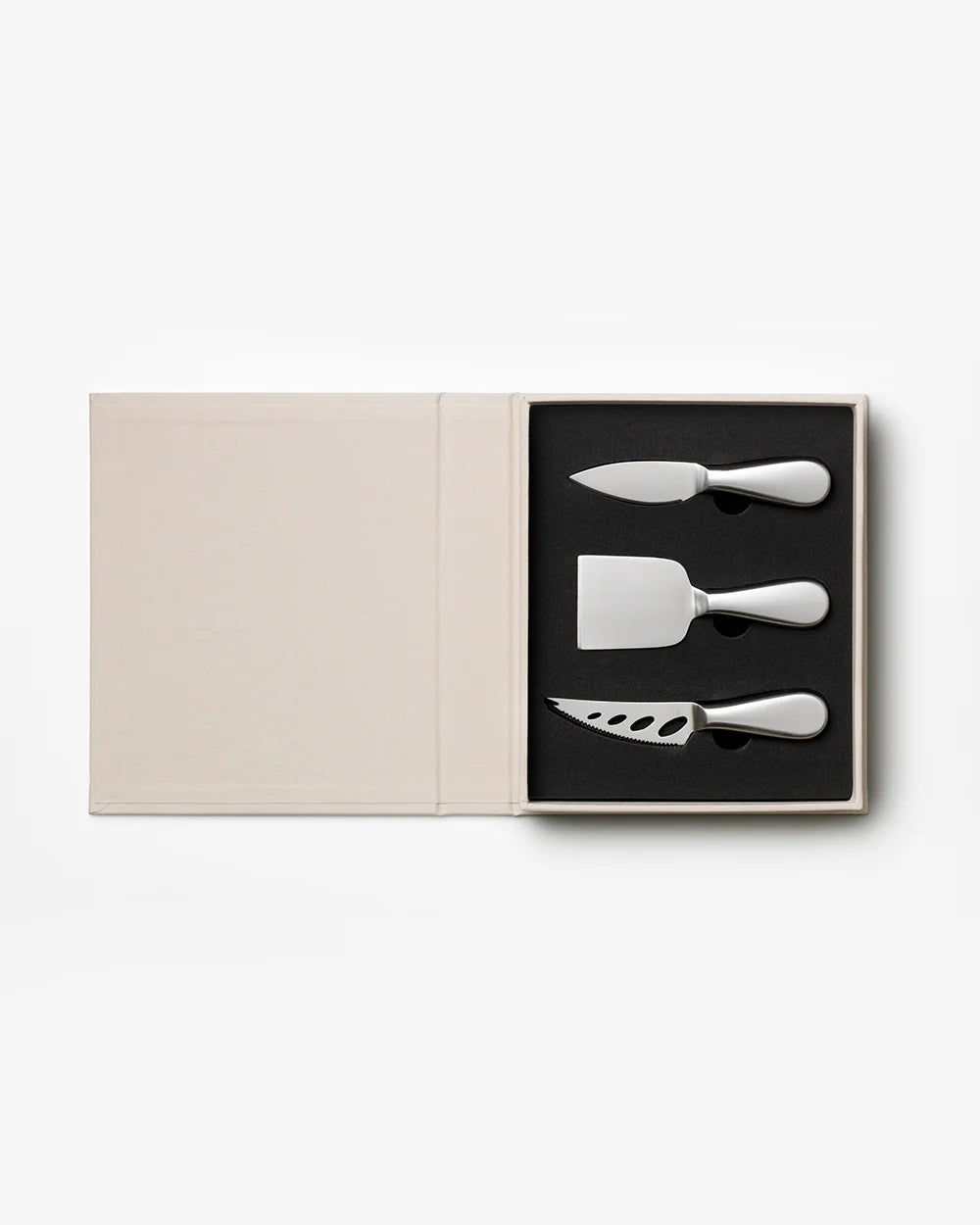 Printworks cheese tools gift set with cheese knives and accessories for serving and slicing cheese, displayed on a wooden board.