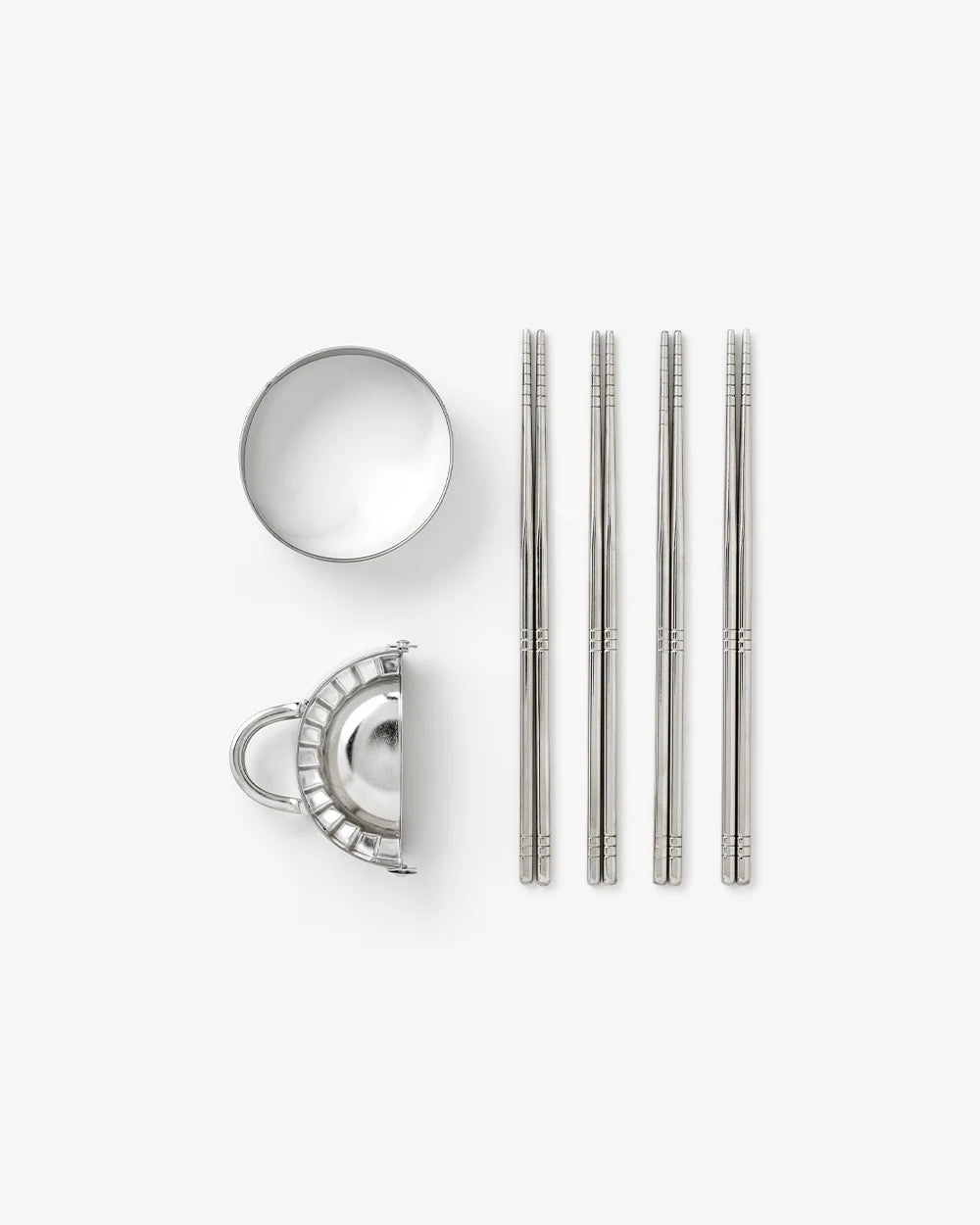 Printworks gift set of dumpling tools with various utensils for making and sealing dumplings, arranged on a clean surface.