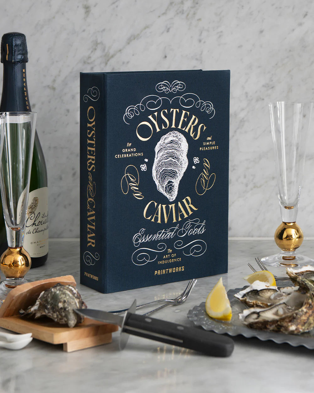 Printworks oyster and caviar tools gift set with oyster shucking knife, caviar spoon, and serving tools on a stylish background.