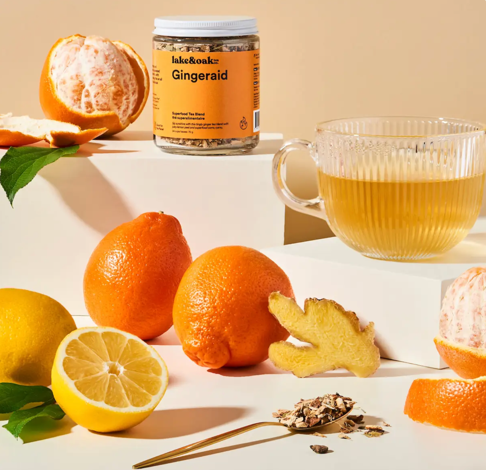 Cup of Lake & Oak Tea Co. Gingeraid herbal tea in a mug, showcasing fresh ginger slices and tea leaves inside.