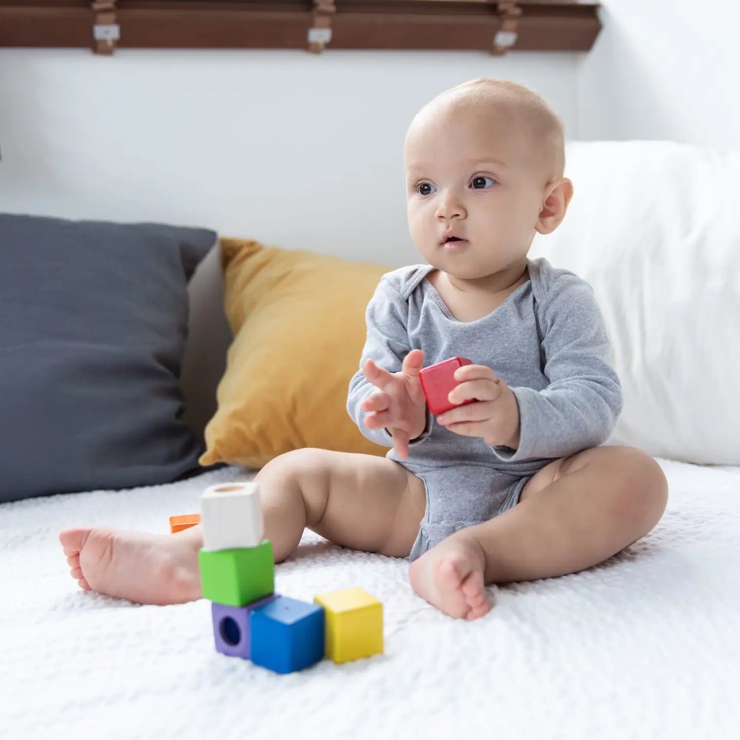 Colorful PlanToys sensory blocks made of natural wood with textured surfaces for tactile play and learning.