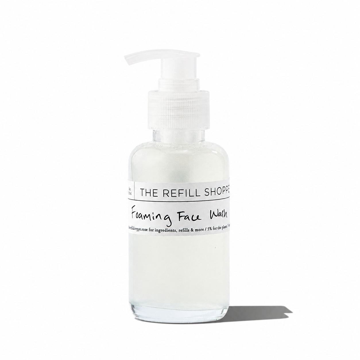 Foaming face wash from The Refill Shoppe, skincare product in a clear pump bottle with foam visible inside.