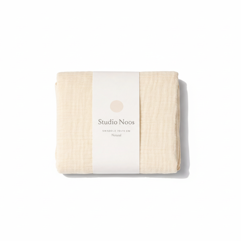Colorful Studio Noos swaddle blanket with soft fabric and vibrant pattern, perfect for wrapping and soothing a baby.