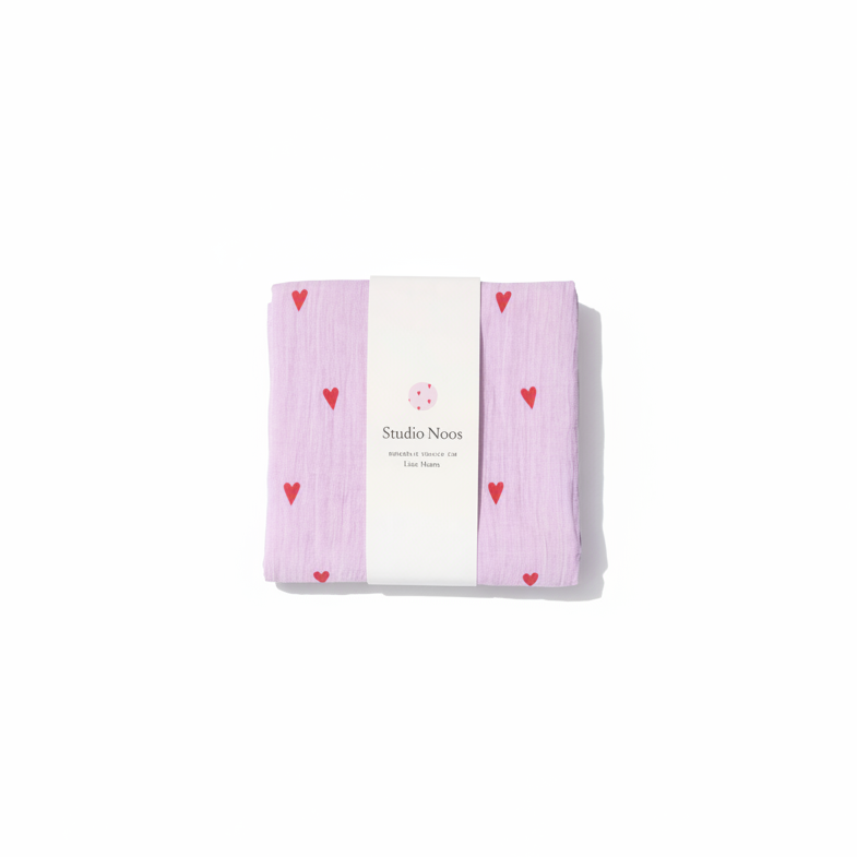 Studio Noos Hearts Swaddle featuring a soft fabric with heart patterns, ideal for wrapping a baby in gentle comfort.