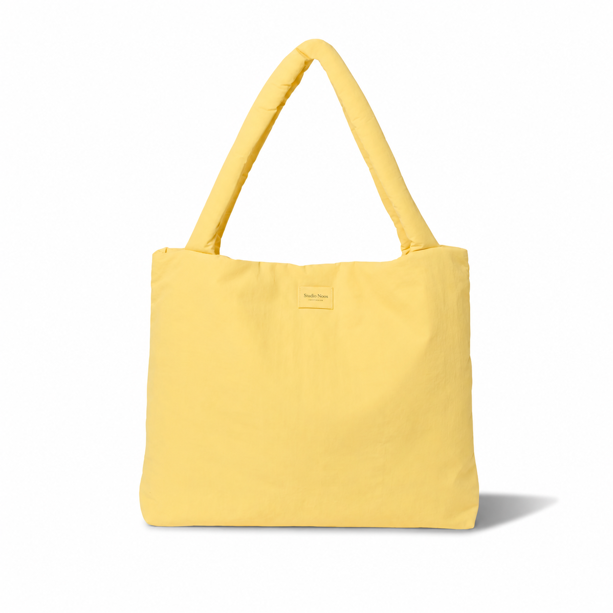 Studio Noos textured puffy mom bag with quilted design, featuring soft, padded material and a spacious interior for everyday use.
