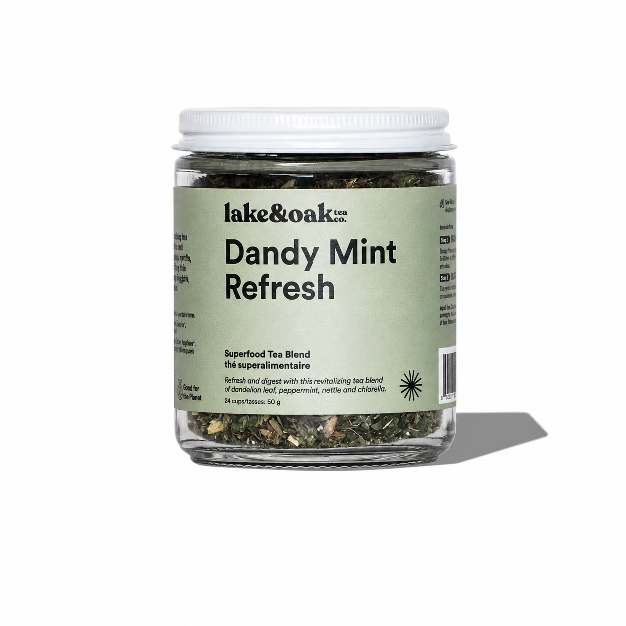 Dandy Mint Refresh tea by Lake & Oak Tea Co. featuring fresh mint leaves and vibrant tea leaves in a clear glass cup.