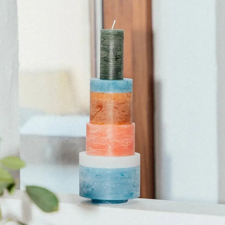 Stack of white ceramic candles from Stan Editions Candl Stack 06 collection, arranged on a wooden surface with a soft background.